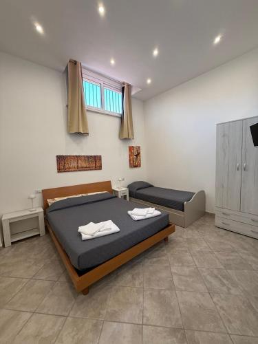 a bedroom with two beds and a television in it at Da Silvi Apartment in Terracina