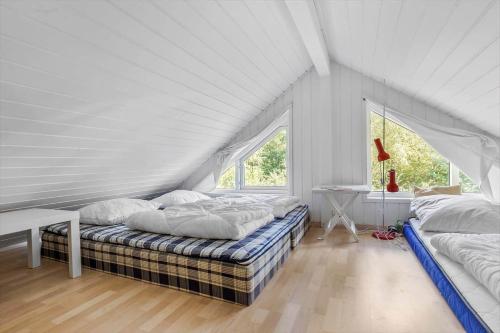 a bedroom with two beds in a attic at 8552-Grenaa-Polderrevsvej-17 in Grenå