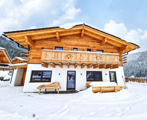 a log home in the snow at Chalets Premium Dachstein in Forstau