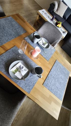 a coffee table with mats and plates on it at HochDrei - Hahnenklee in Goslar