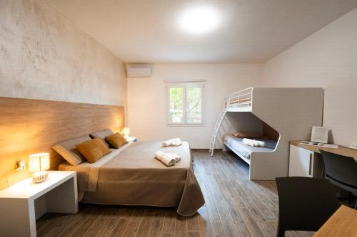 a bedroom with a bed and a bunk ladder at Miluna Affittacamere in Siniscola