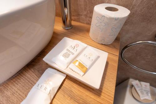 a table with a roll of toilet paper and a toilet paper holder at Miluna Affittacamere in Siniscola