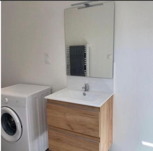 a bathroom with a sink and a washing machine at Pomorie appartement ad in Pomorie