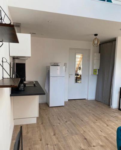 a kitchen with a white refrigerator and a counter at Pomorie appartement ad in Pomorie