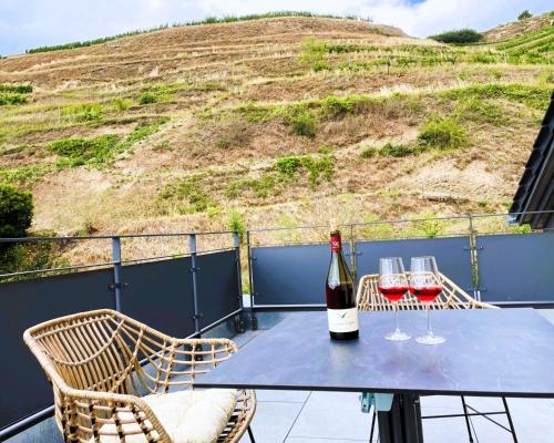 a table with two glasses of wine on a balcony at Apartment Wendehals in Vogtsburg