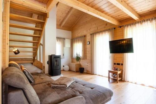 a bedroom with a large bed in a room with wooden ceilings at Chalet am Zirm in Riobianco