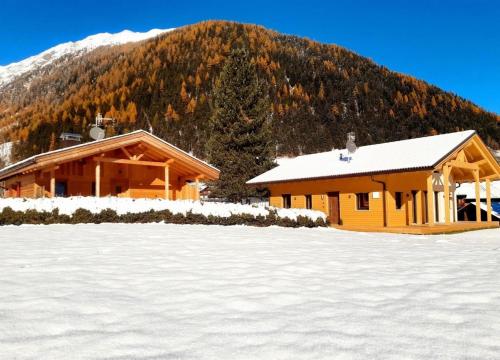 a log cabin in the snow in front of a mountain at Chalet am Zirm in Riobianco