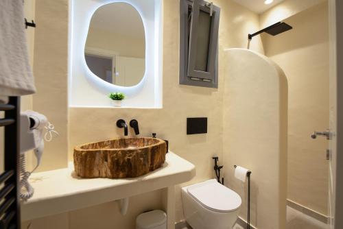 a bathroom with a wooden sink and a toilet at Amara Serifos in Serifos Chora