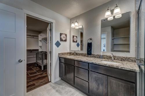 a bathroom with two sinks and a large mirror at Executive Stay for Work & Family in Rapid City