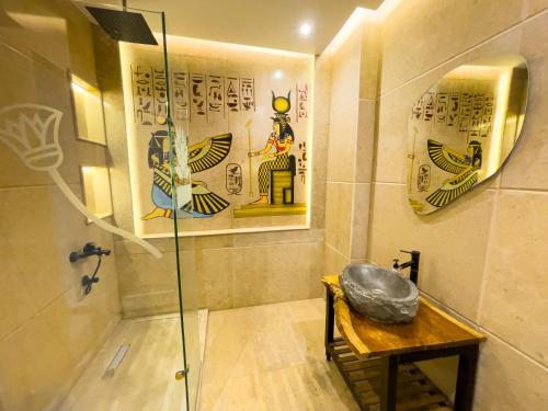 a bathroom with a shower with a table and a mirror at Luxurious GEM and PYRAMIDS view in Cairo
