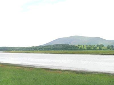a large body of water with mountains in the background at Martha's Shore Cottage in Glencaple