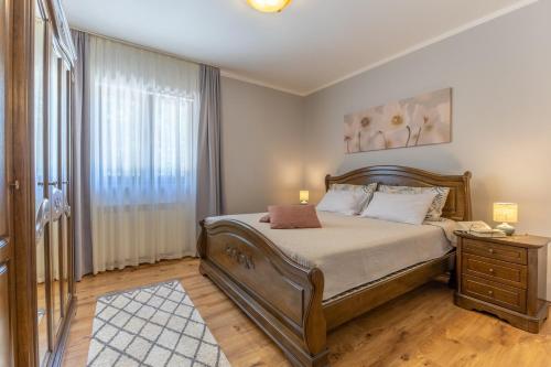 a bedroom with a large bed and a window at Villa Antonela in Radetići