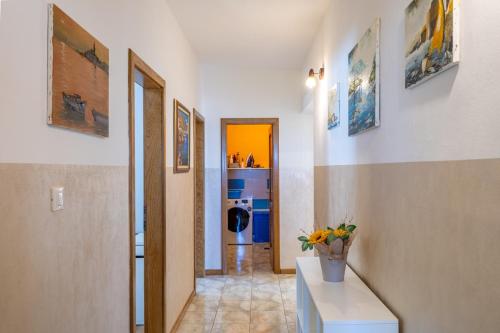 a room with a hallway with a counter with flowers on it at Villa Antonela in Radetići