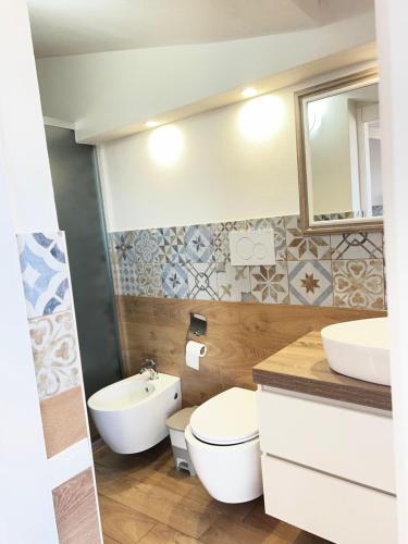 a bathroom with a toilet and a sink at Cuore Selargius in Selargius