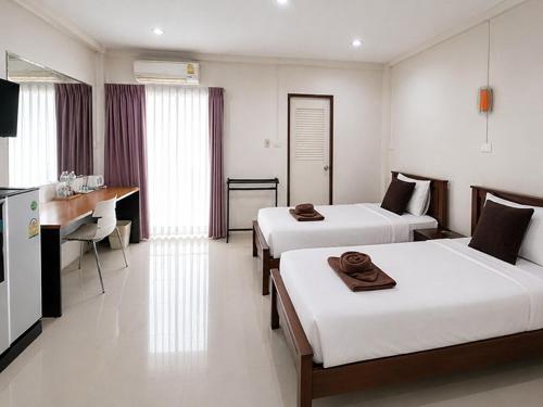 a hotel room with two beds and a kitchen at Bann Lhong Rak Krabi in Krabi