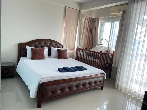 a bedroom with a bed with two blue towels on it at Bann Lhong Rak Krabi in Krabi
