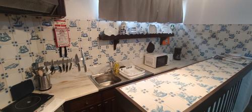 a kitchen with blue and white tiles on the wall at Villa Golden Coast - Lagos in Lagos