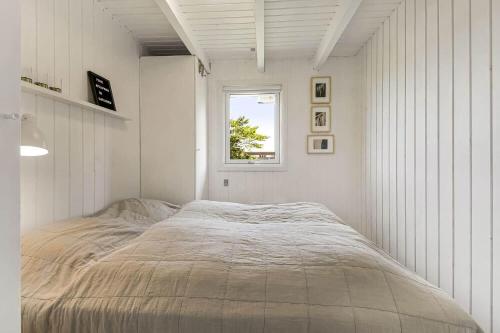 a bed in a white room with a window at C11596-Hemmet-Vester-Faelled-51 in Hemmet