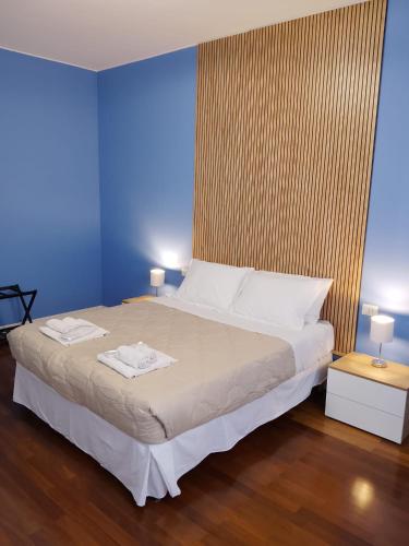 a bedroom with a bed with two towels on it at Beautiful Home Mxp in Gallarate