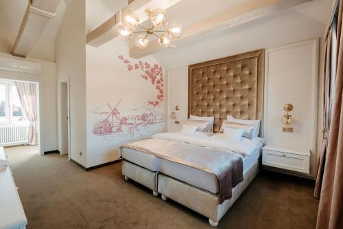 a bedroom with a large bed with a large headboard at Hotel Bojnický vínny dom in Bojnice