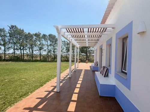 a pergola on the side of a house at O Monte da Estrada in Zambujeira do Mar