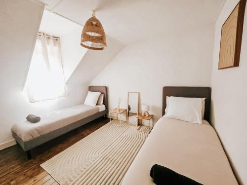 a bedroom with a bed and a couch and a window at Champagne getaway, spacious house in Épernay