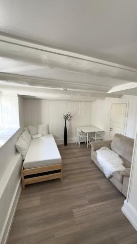 a bedroom with a bed and a couch and a table at ONS 2026 Economic Central accommodation in Stavanger