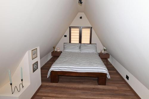 a bedroom with a bed in a attic at Kiki house in Čačak