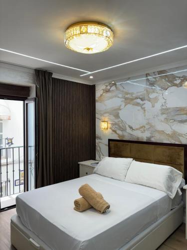 a bedroom with a bed with a towel on it at Boutique Princesa in Marbella