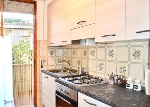 a kitchen with a sink and a stove at Vicolo della Chiusa in Rosia