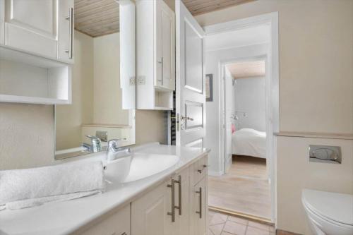 a white bathroom with a sink and a toilet at 1670-Melby-Kragesvej-36 in Melby