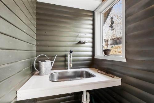 a bathroom with a sink and a window at 8881-Glesborg-Benzonstien-27 in Fjellerup Strand