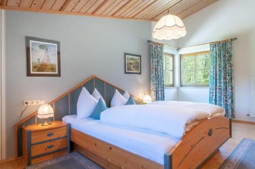 a bedroom with a large bed with a wooden headboard at Jägers Highlineblick in Breitenwang