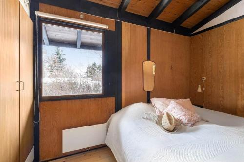 a bedroom with a bed with a window in it at 1673-Hundested-Moller-Ager-7 in Hundested