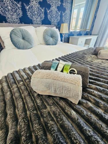 a bedroom with a bed with a blanket and pillows at Luxury Home with Pool in Barnsley
