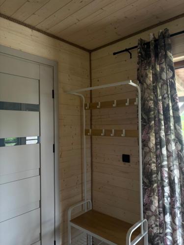 a room with a wooden wall with a bunk bed at Domki Stokrotka in Ruciane-Nida