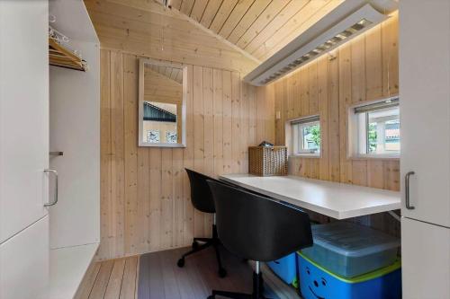 a small kitchen with a desk in a tiny house at 84256-Ronde-Strandvejen-108 in Rønde