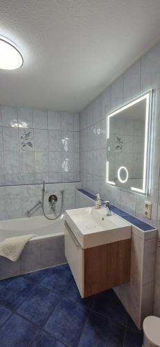 a bathroom with a sink and a bath tub at Traumblick in Kempten