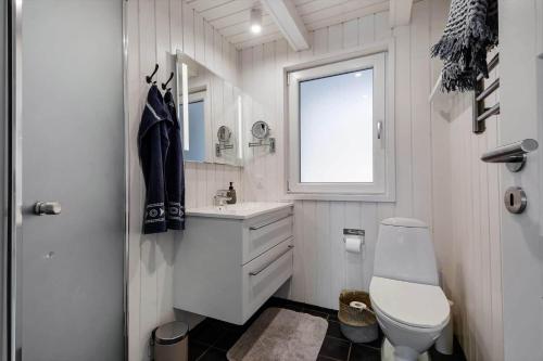 a bathroom with a toilet and a sink and a window at C11638-Hemmet-Vester-Faelled-49 in Hemmet