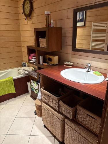 a bathroom with a sink and a bath tub at Villa Serena offrez vous une parenthese in Le Porge