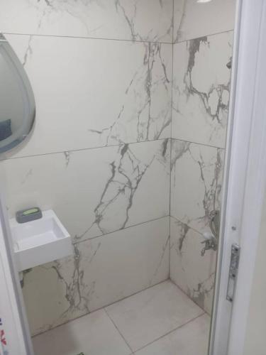 a bathroom with a marble shower with a sink at La perle de Sétif in Sétif