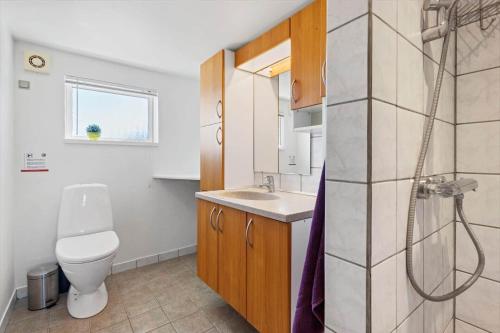 a bathroom with a toilet and a sink at 8501-Grenaa-Ellevej-14 in Grenå Strand