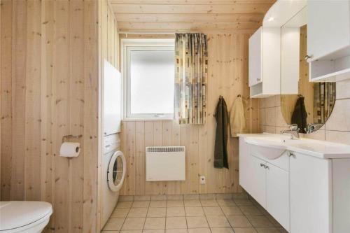 a bathroom with a sink and a toilet and a window at 30729-Odder-Alrovej-203-C in Odder