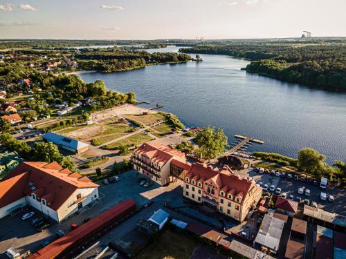 an aerial view of a building next to a river at Hotel Stara Gorzelnia in Licheń Stary