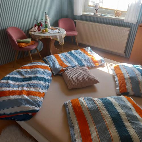 a bed with two pillows on it in a room at Zimmer und Apartment Rosi in Krakow am See