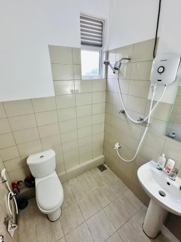 a bathroom with a toilet and a sink at Urban Nest Studio in Homagama