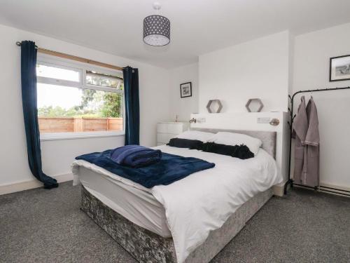 a bedroom with a large bed and a window at Fox Retreat in Ganton