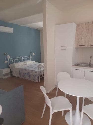 a room with a table and chairs and a bed at Casa Morano in Schiavonea
