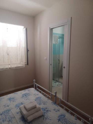 a bedroom with a bed and a large mirror at Casa Morano in Schiavonea