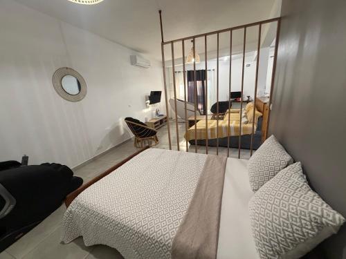 a bedroom with a bed and a living room at Makeda in Chiconi